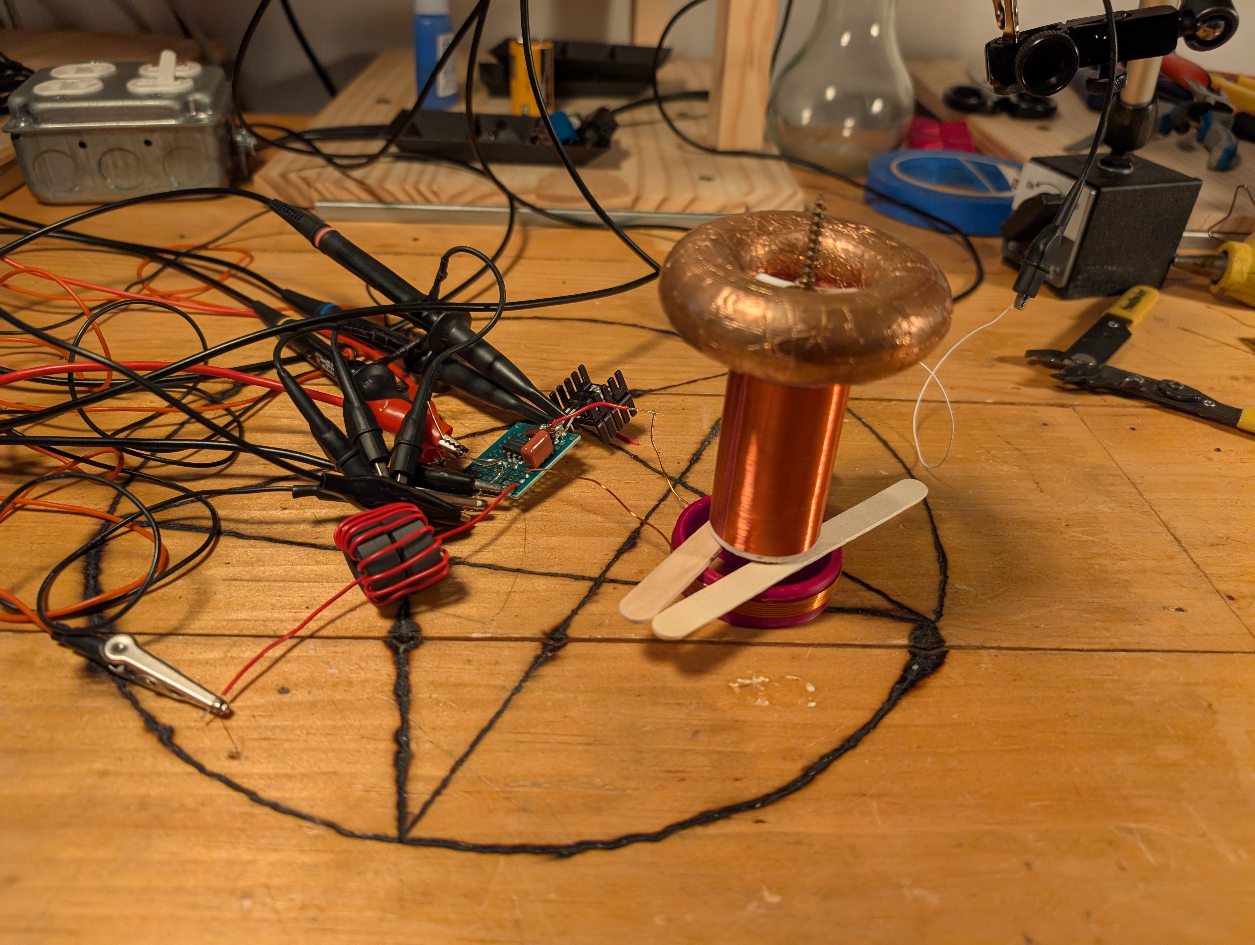 a tesla coil and a driver on the bench