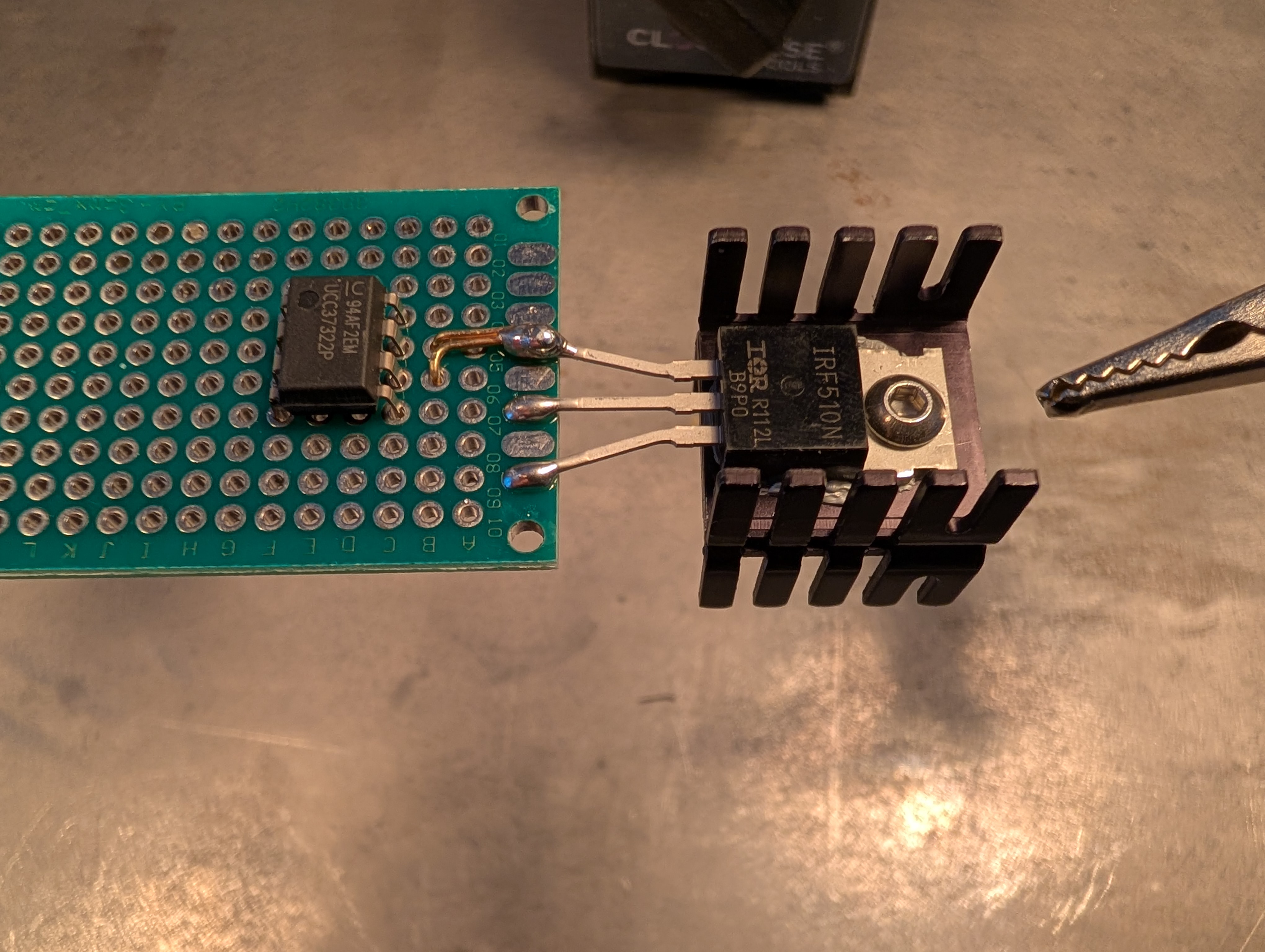 a perfboard with a FET and PDIP-8 soldered to it