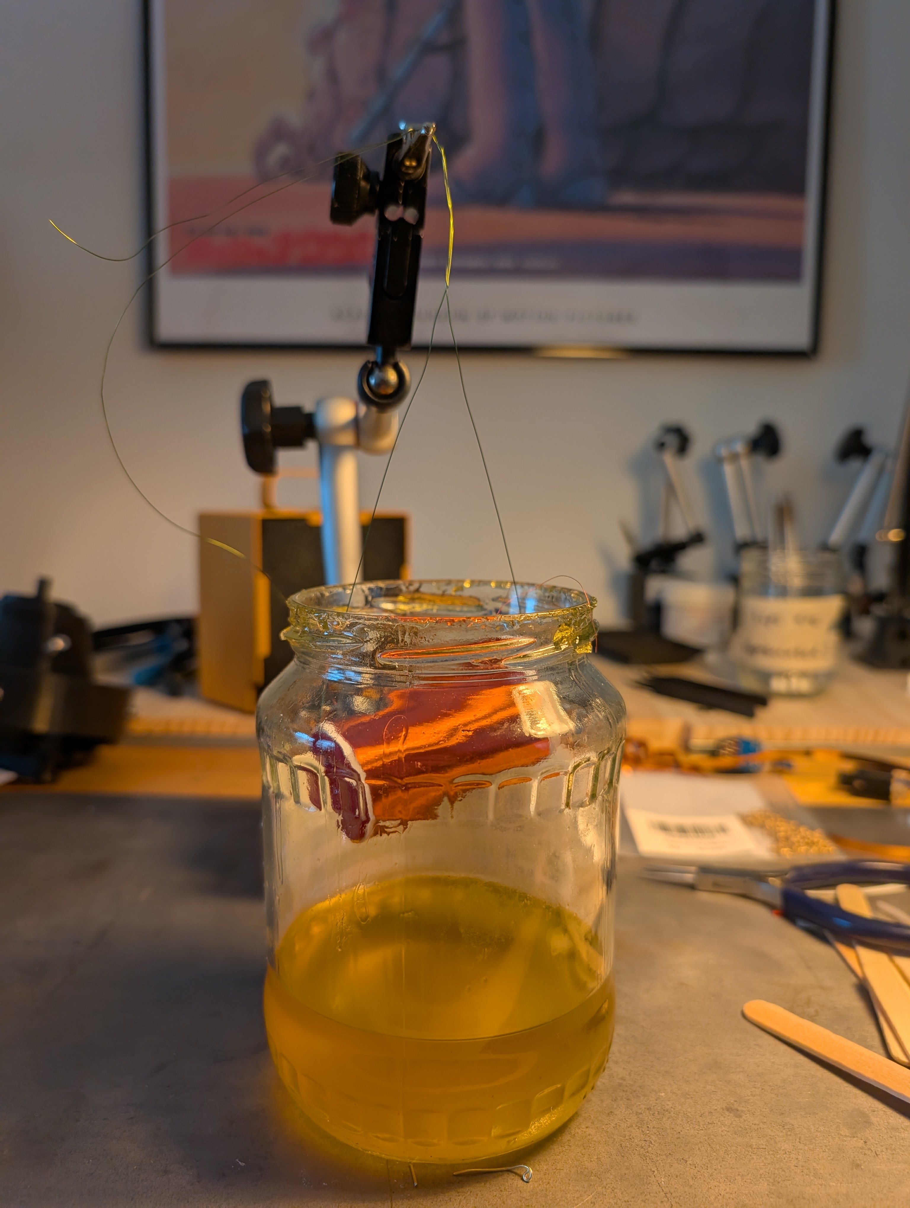 the secondary coil hanging inside a jar of shellac